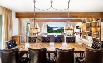 a dining room with a large table and chairs