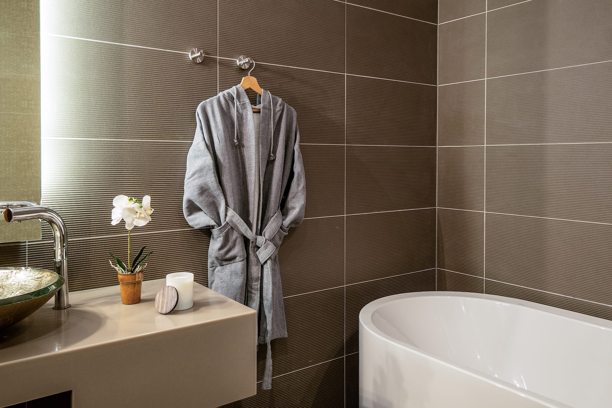 a bathrobe on a hook in a bathroom