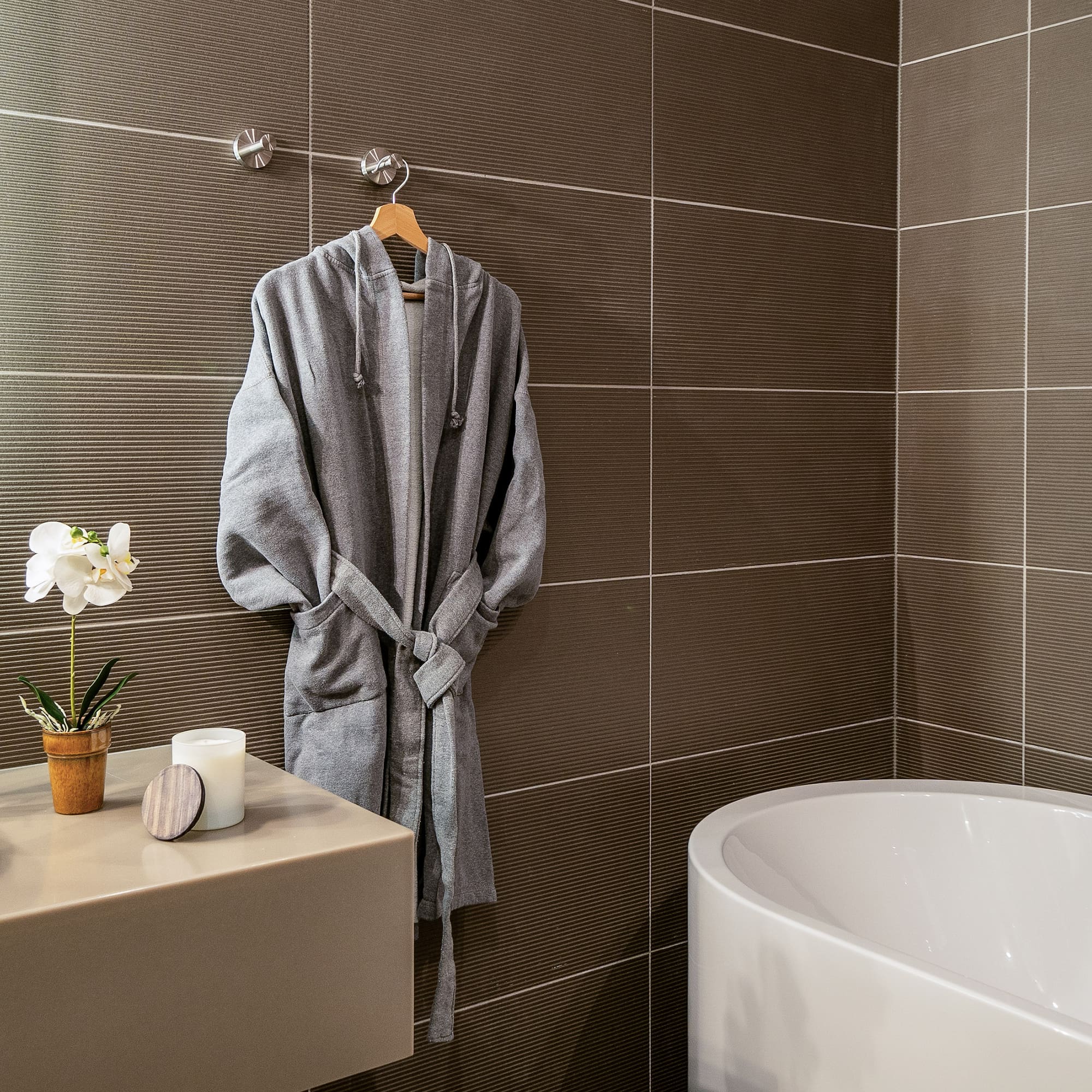 a bathrobe on a hook in a bathroom