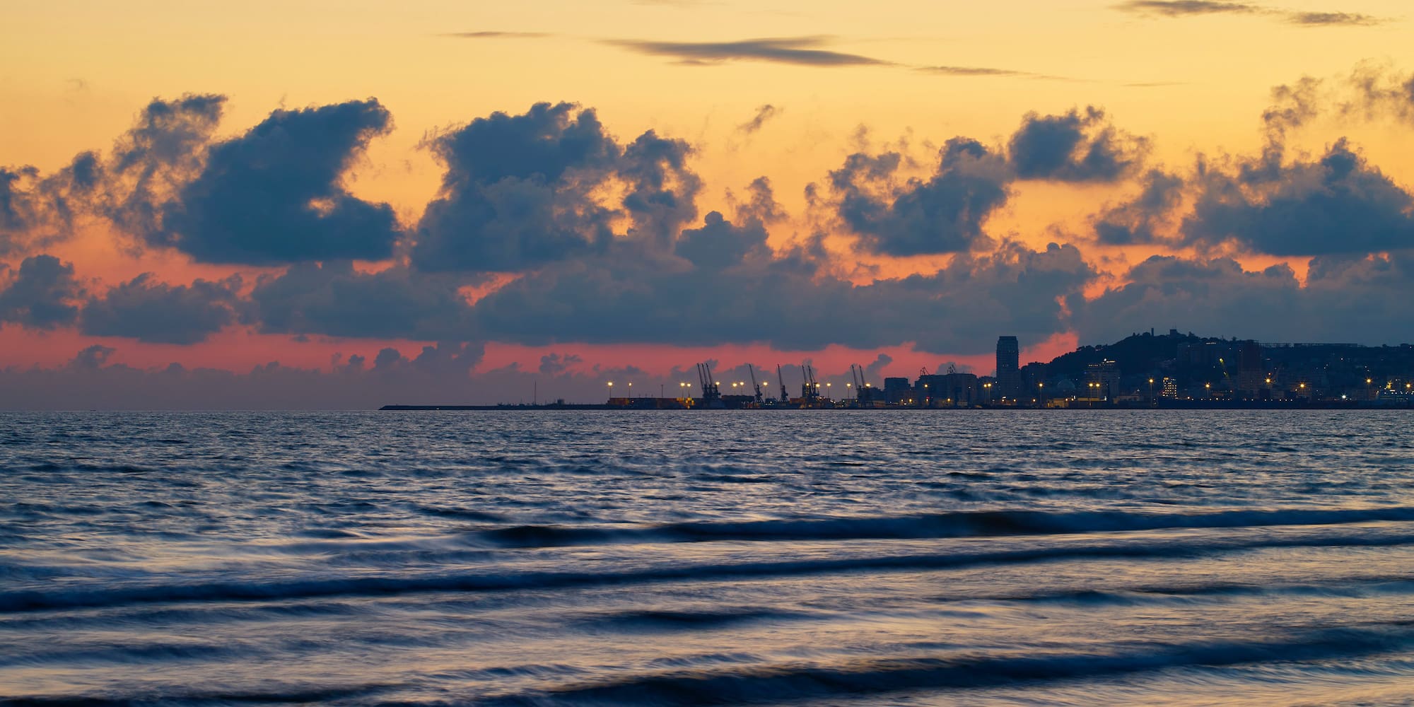 a body of water with a city in the distance