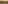 Sunset over wavy ocean, distant city skyline with port cranes.