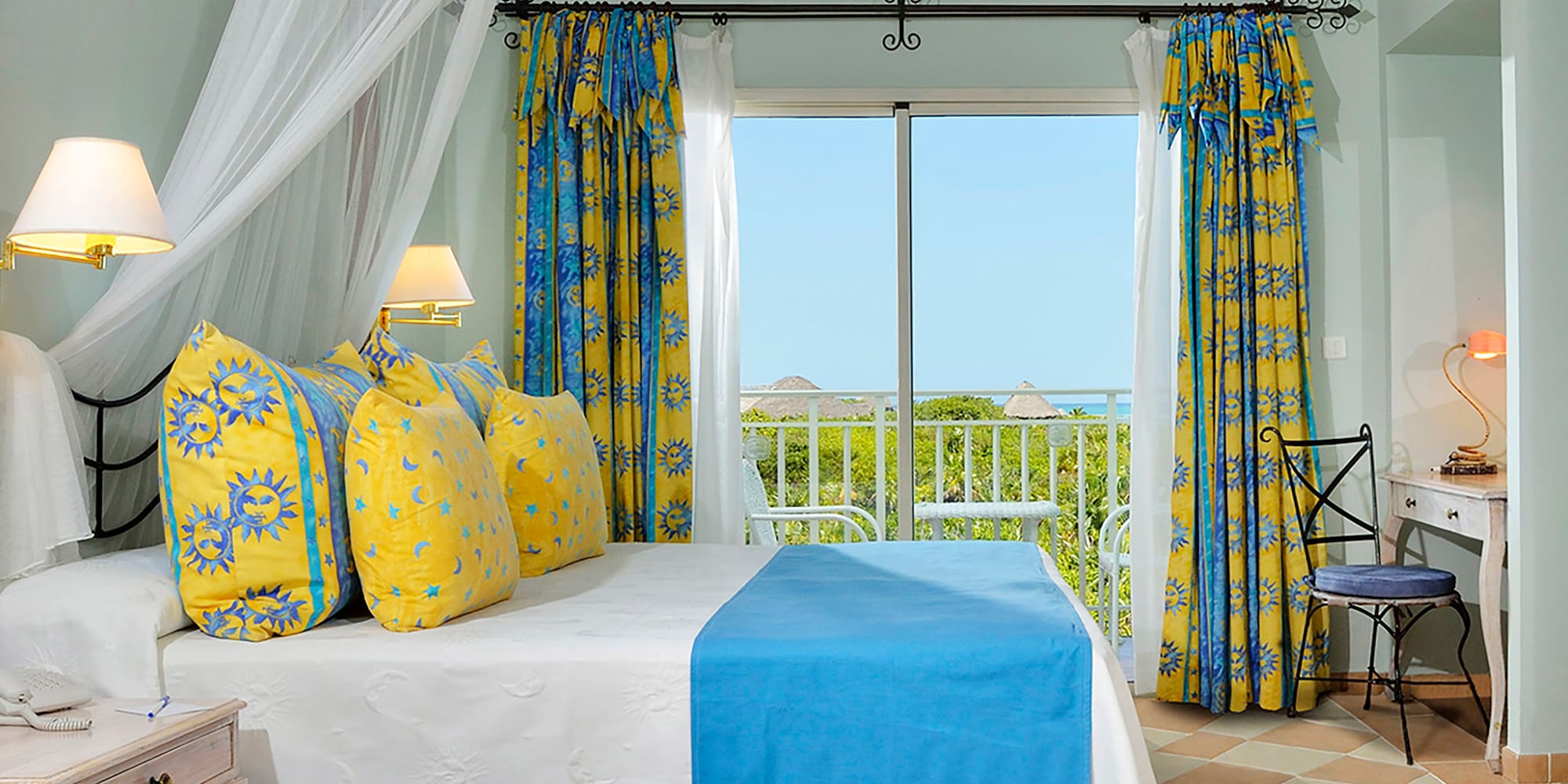 a bed with yellow and blue curtains