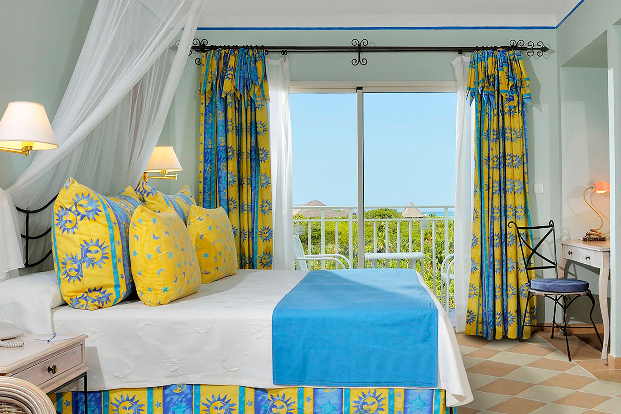 a bed with yellow and blue curtains