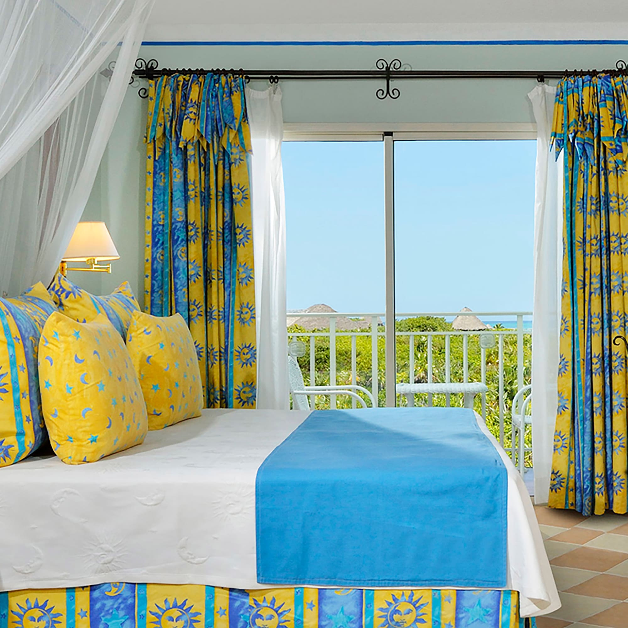 a bed with yellow and blue curtains