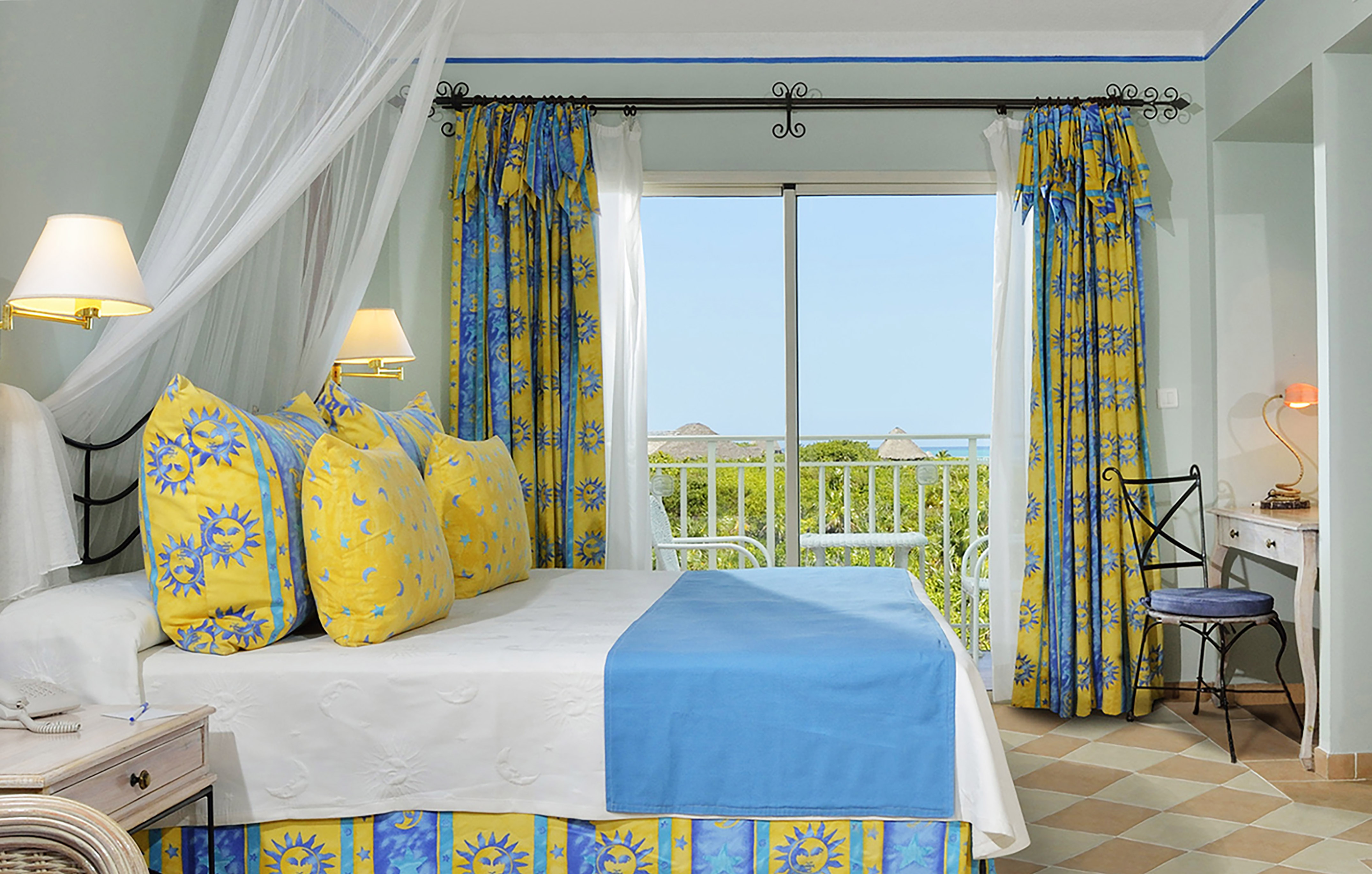 a bed with yellow and blue curtains
