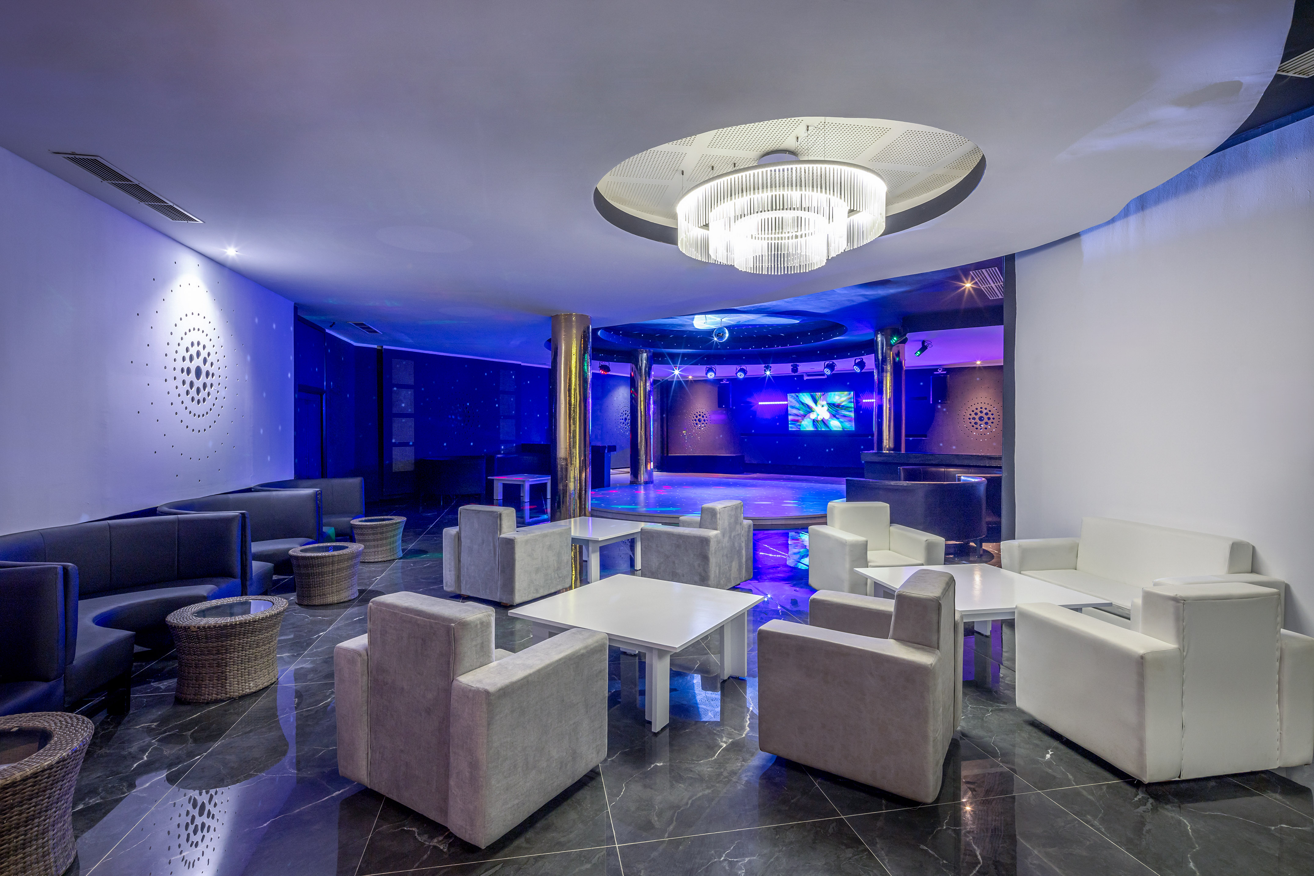 a room with white furniture and a round ceiling