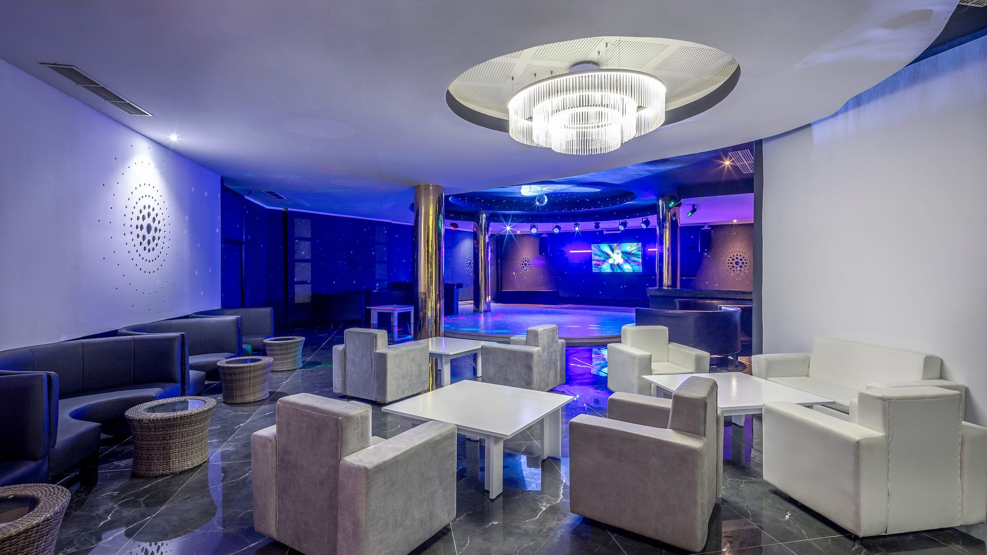 a room with white furniture and a round ceiling