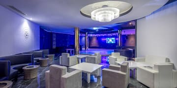 a room with white furniture and a round ceiling