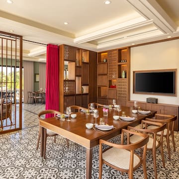 a dining room with a tv and a table