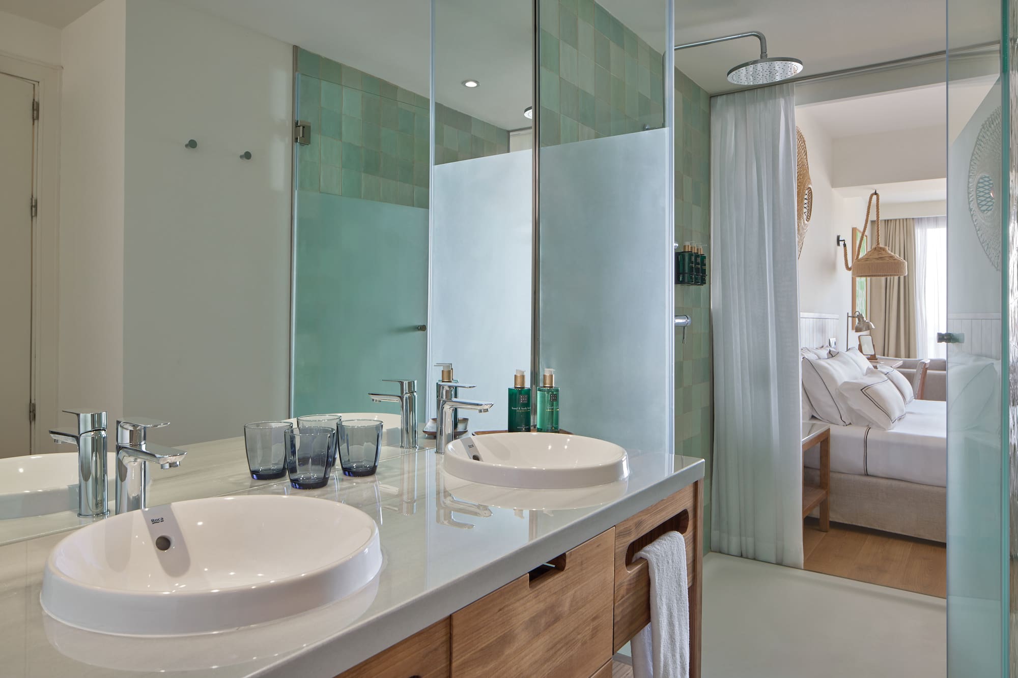 a bathroom with a shower and two sinks