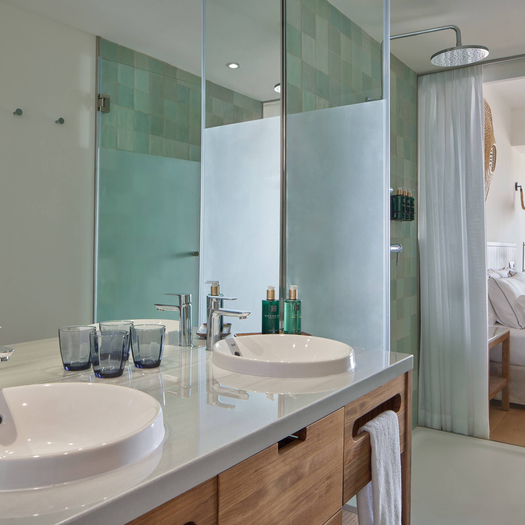 a bathroom with a shower and two sinks