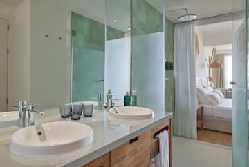 a bathroom with a shower and two sinks