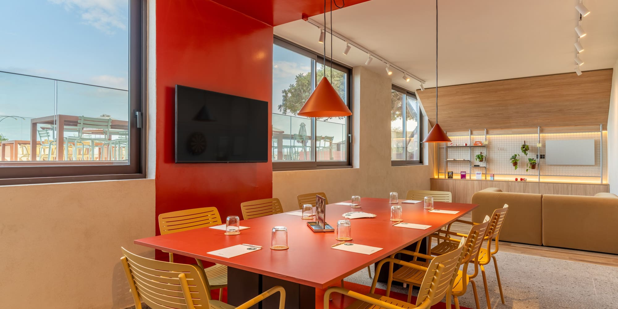 a room with a red table and chairs