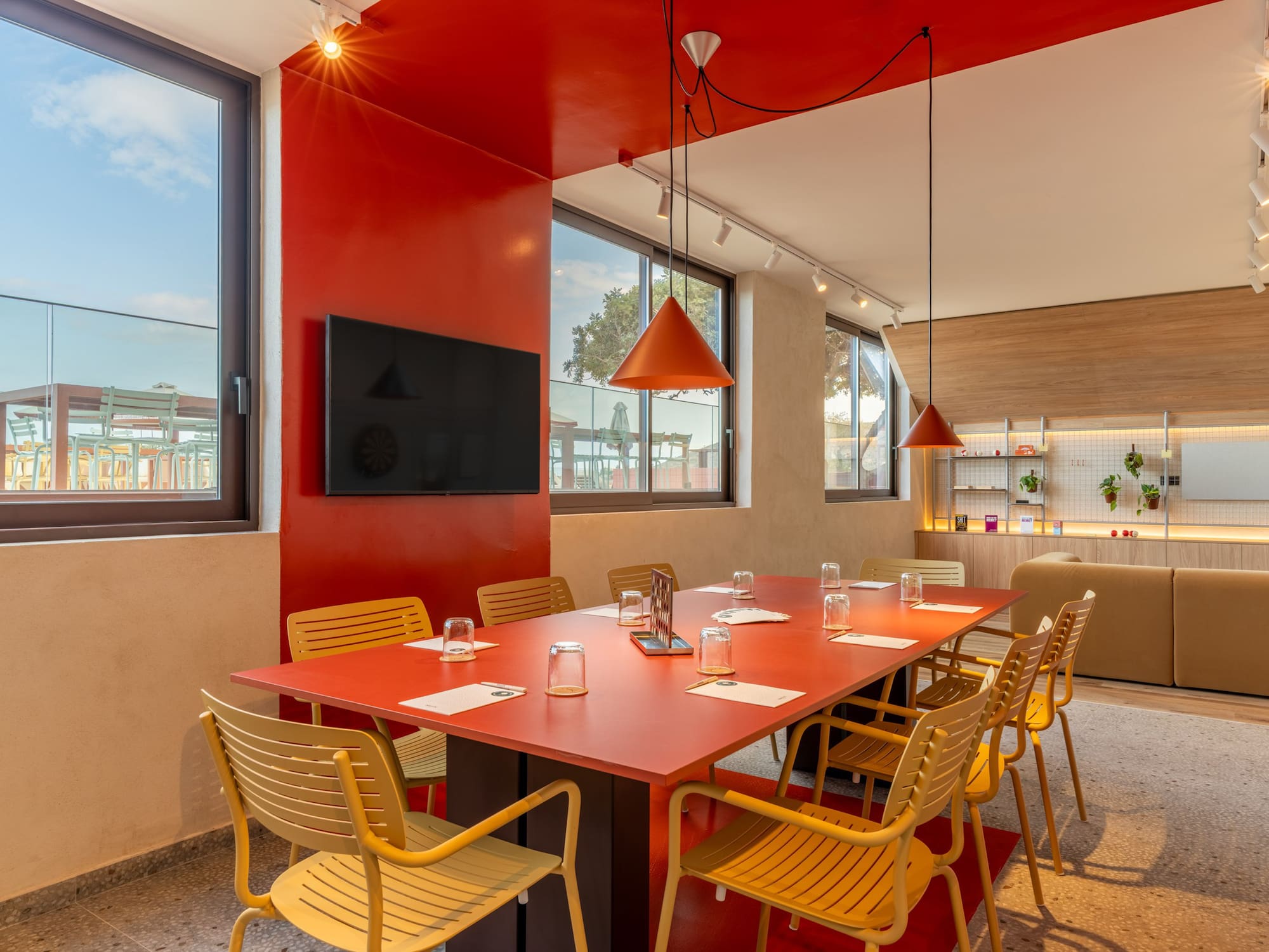a room with a red table and chairs