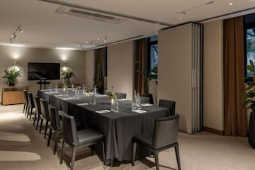 a long table with black tablecloth and chairs