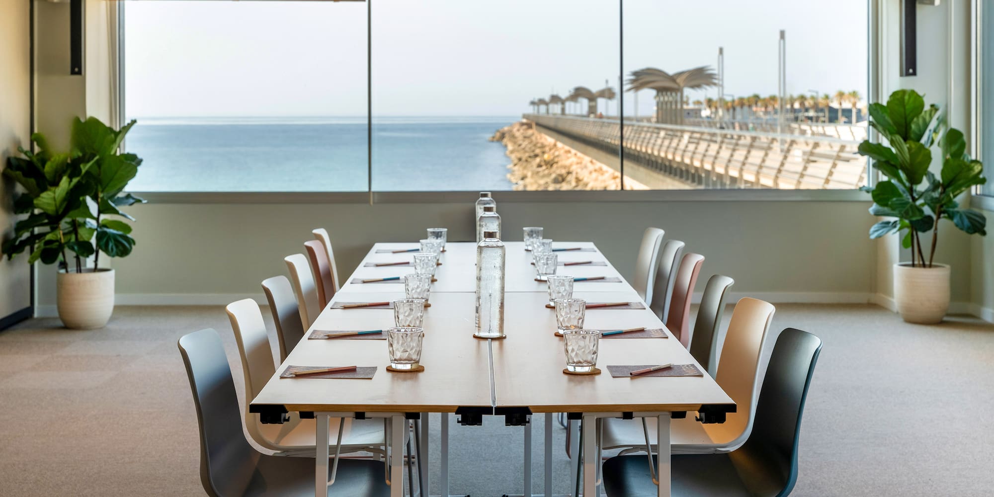 a table with chairs and a view of the ocean