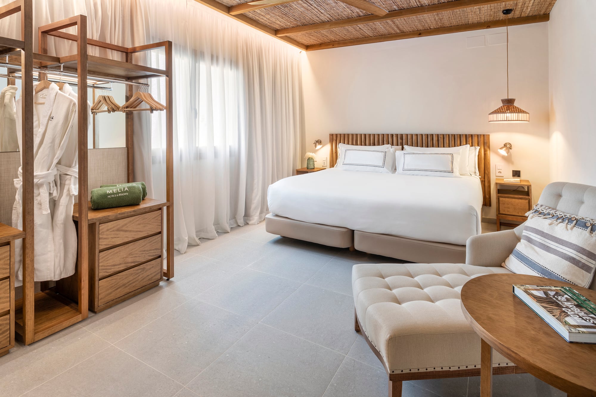 a bedroom with a bed and a chair