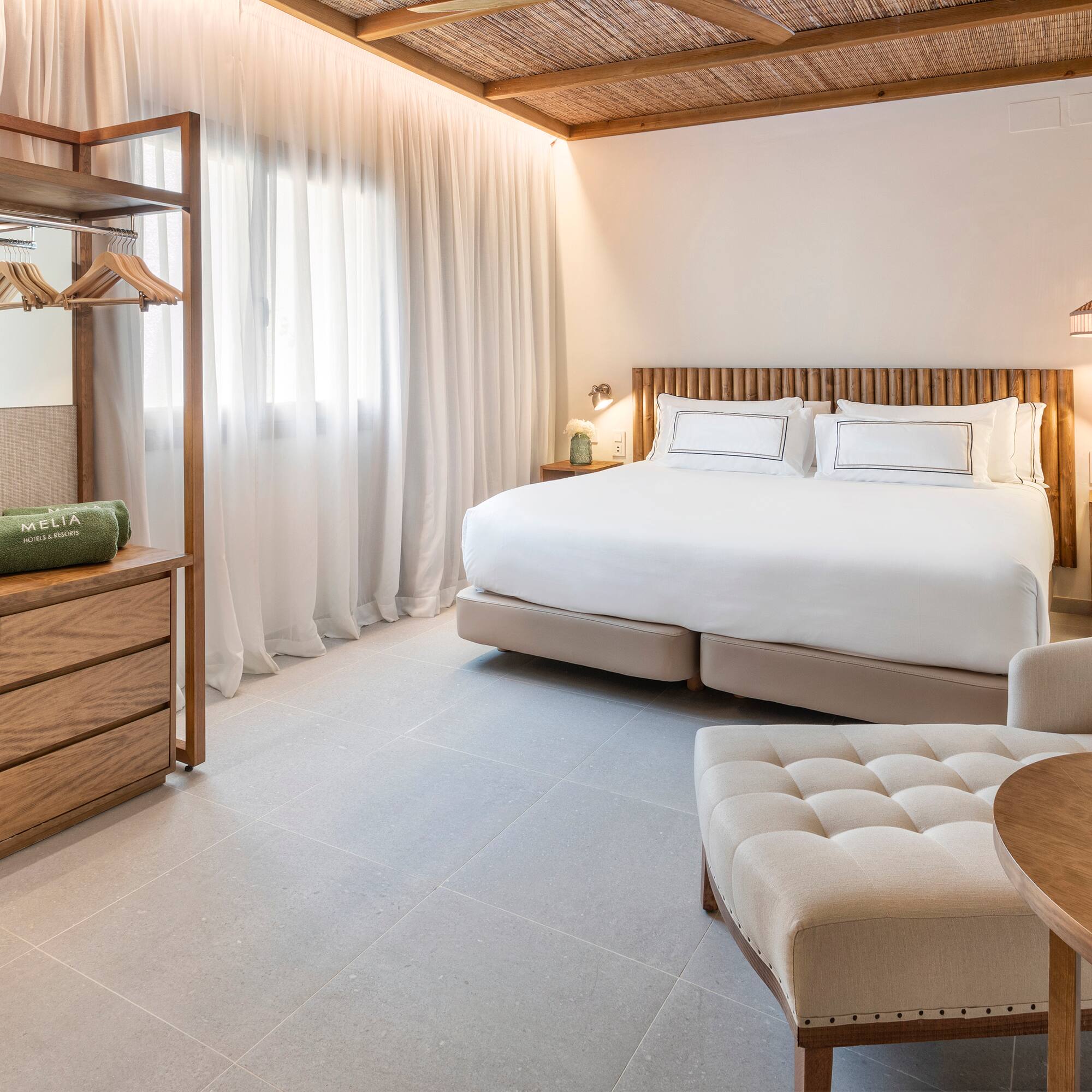 a bedroom with a bed and a chair