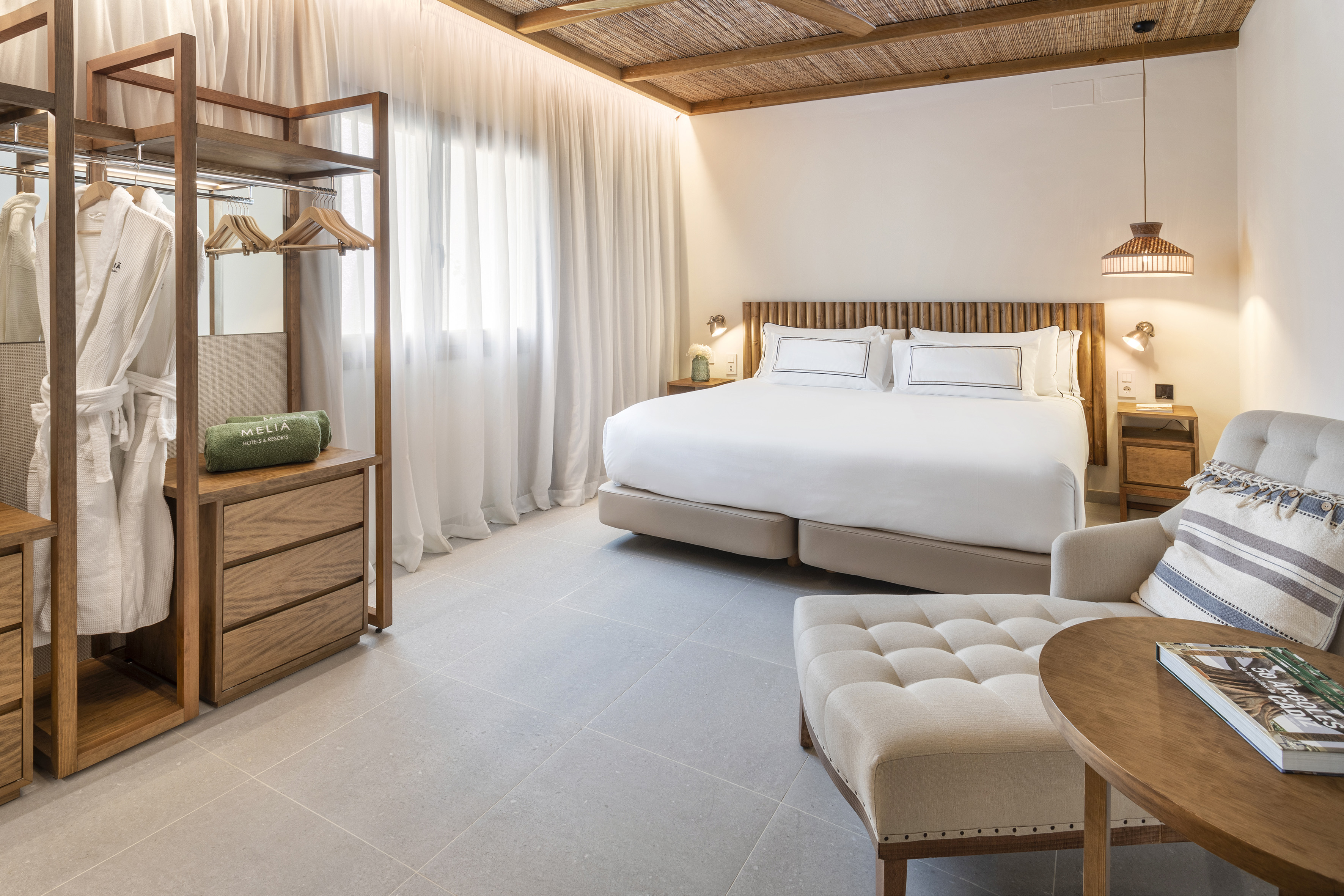 a bedroom with a bed and a chair