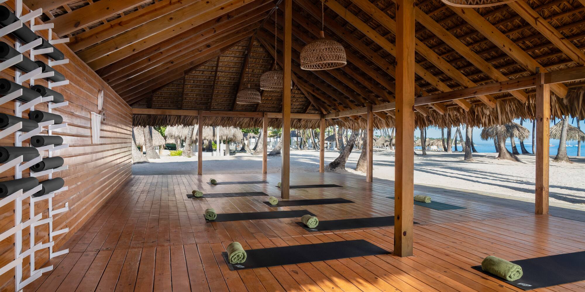 yoga mats on mats in a room with a beach in the background