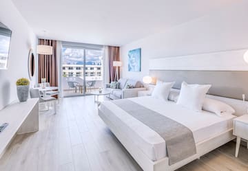 a bedroom with a bed and a couch