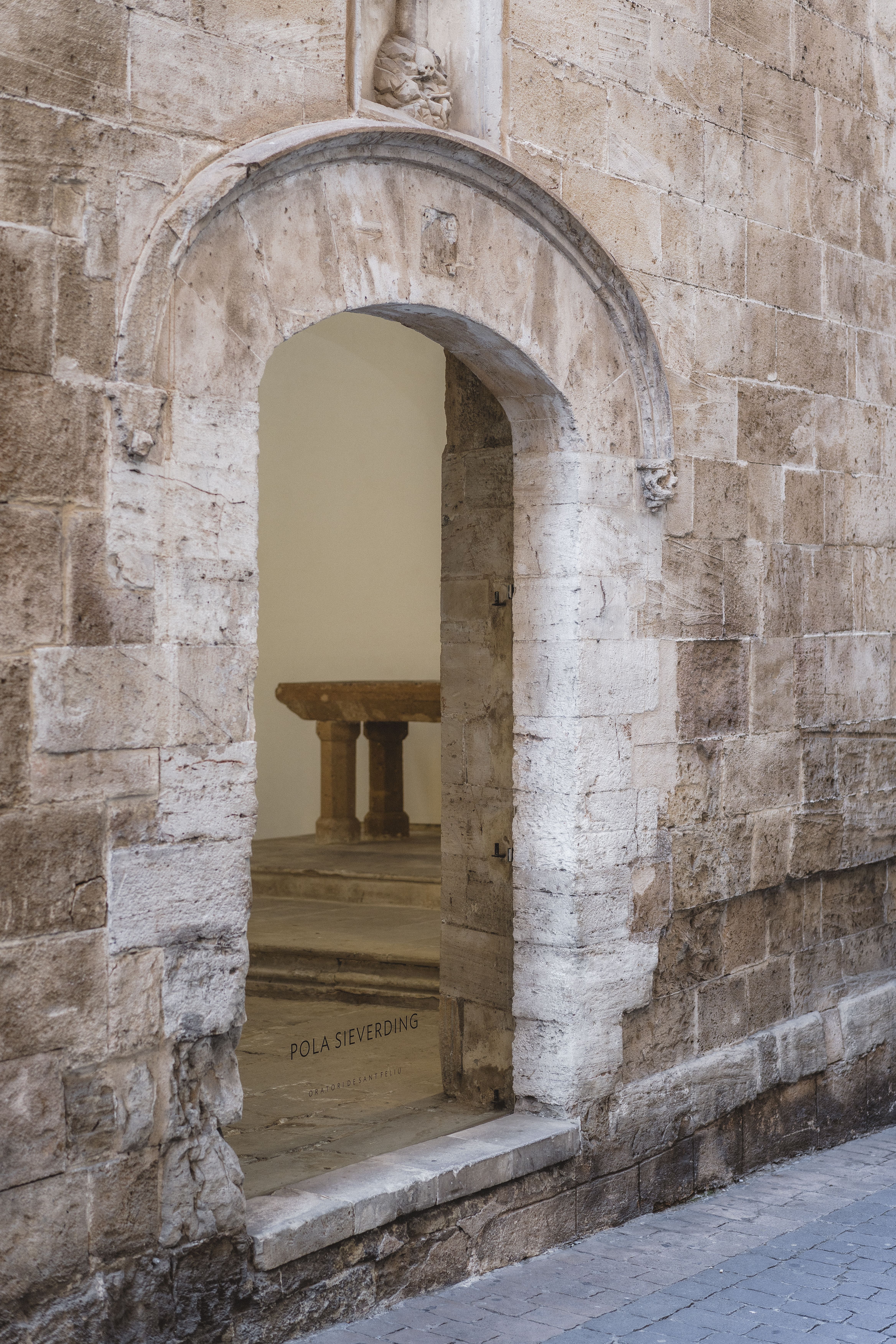 a stone archway with a table in the background