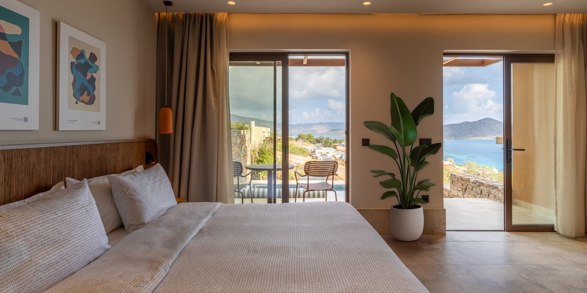 a bedroom with a large bed and a glass door