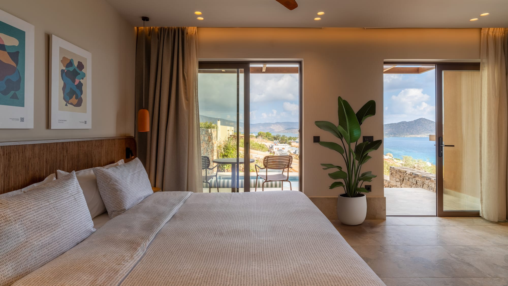 a bedroom with a large bed and a glass door