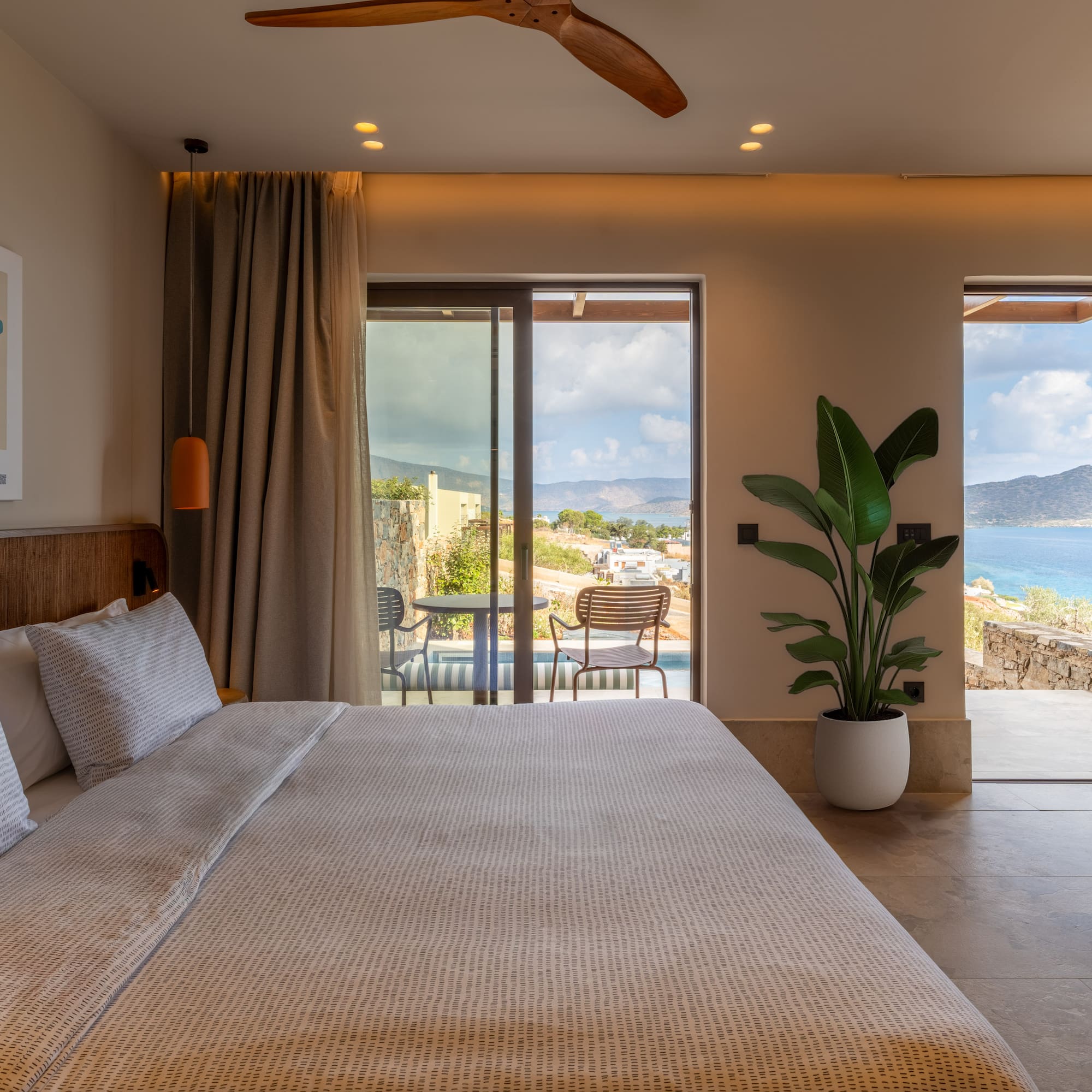 a bedroom with a large bed and a glass door