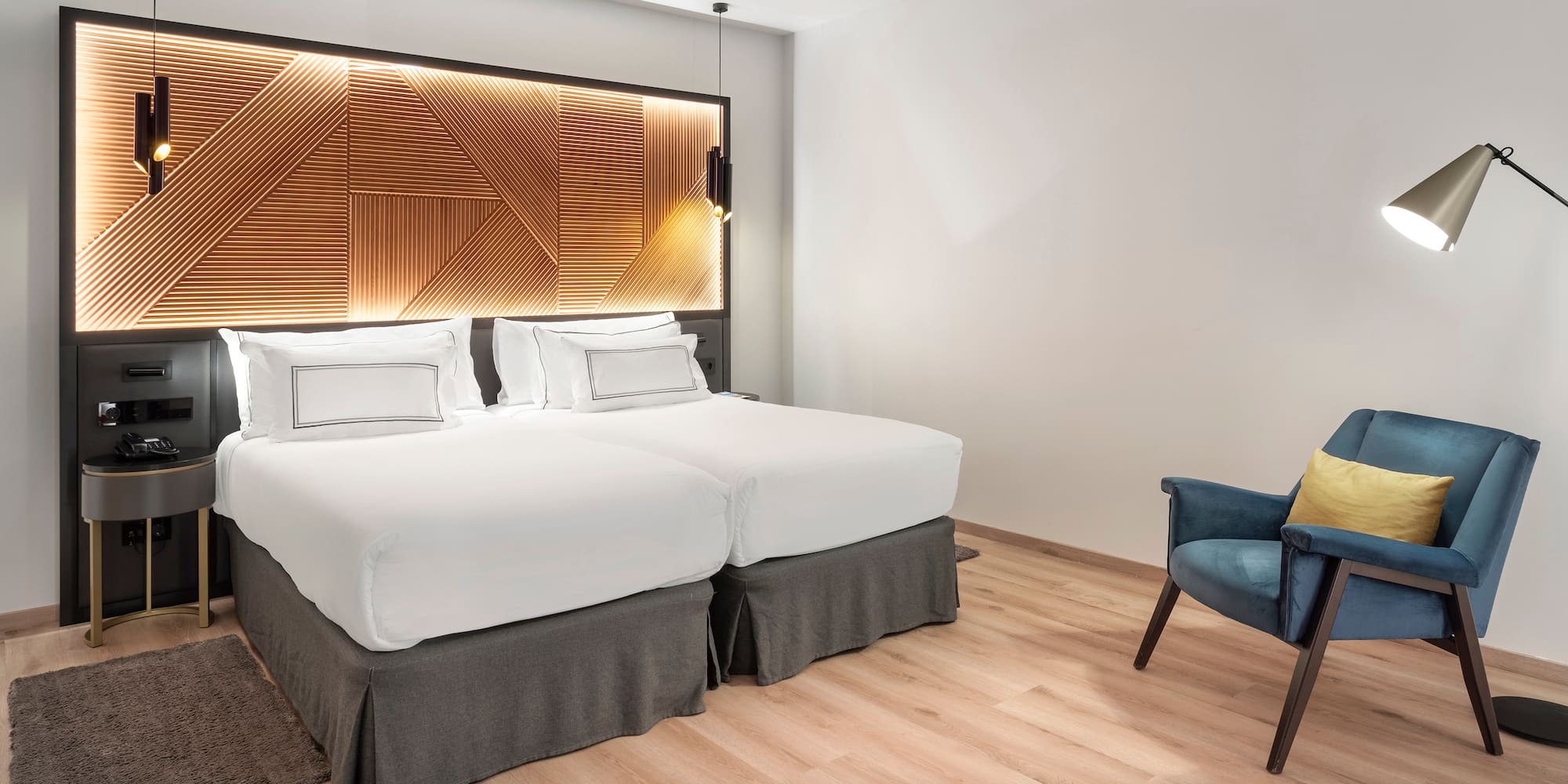 a room with two beds and a chair