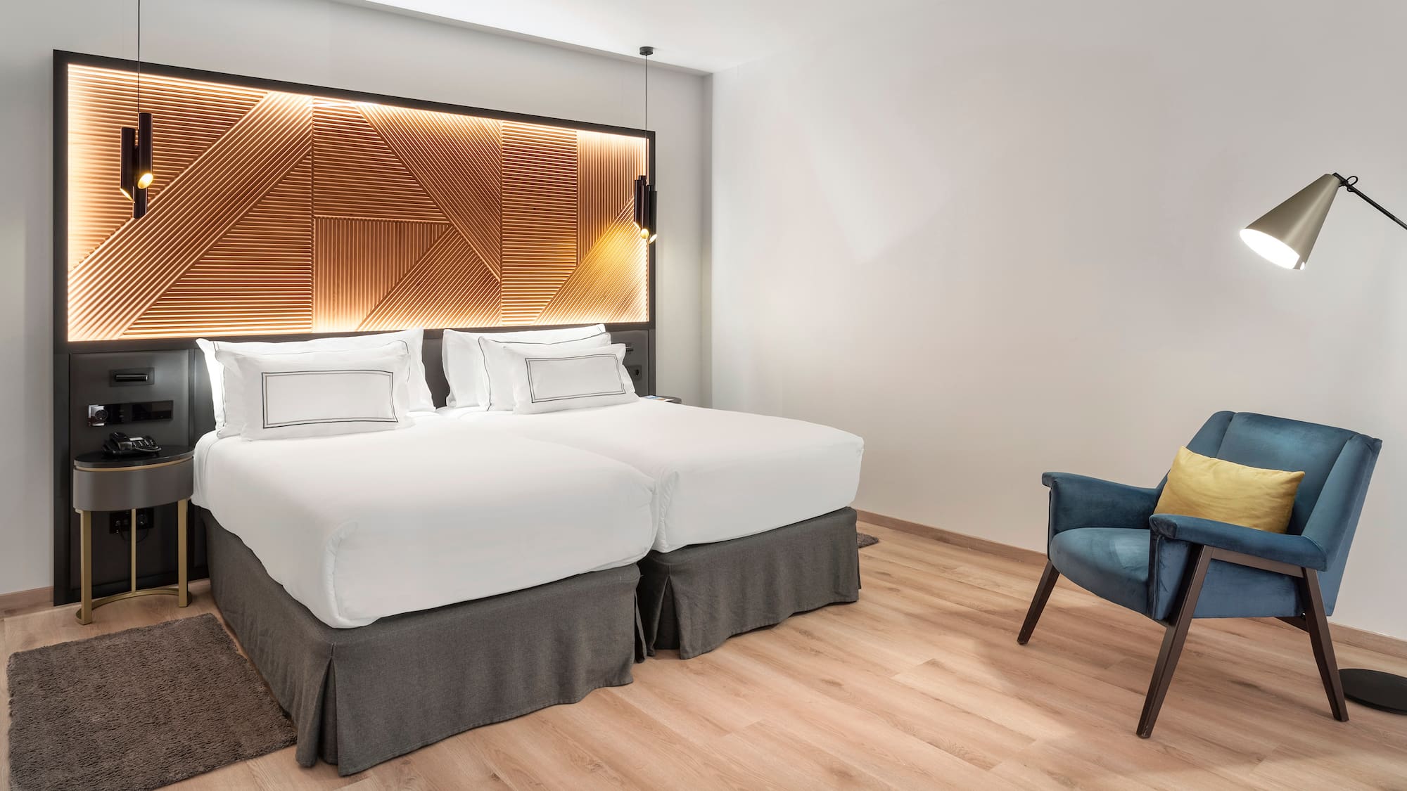 a room with two beds and a chair