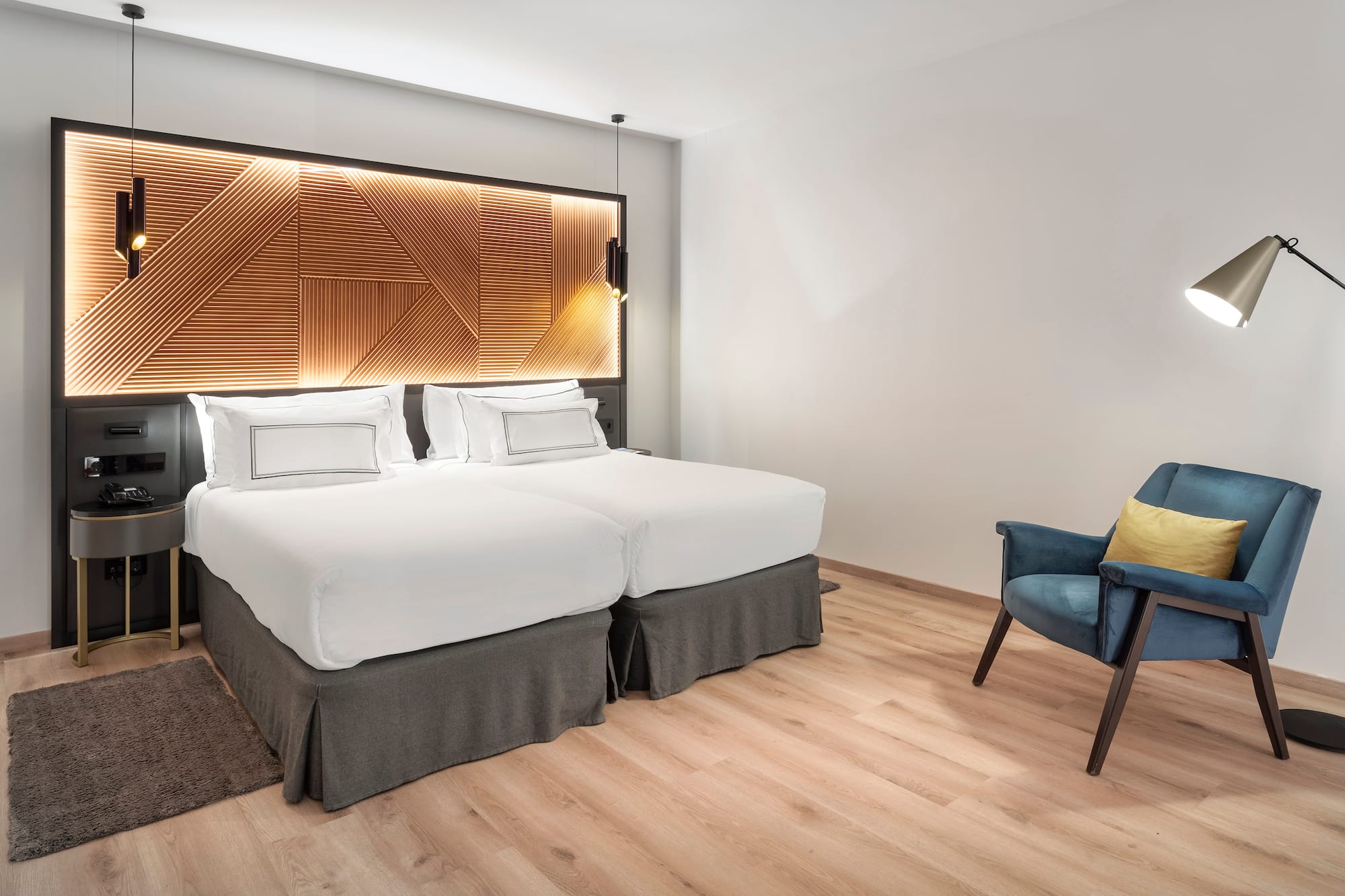 a room with two beds and a chair