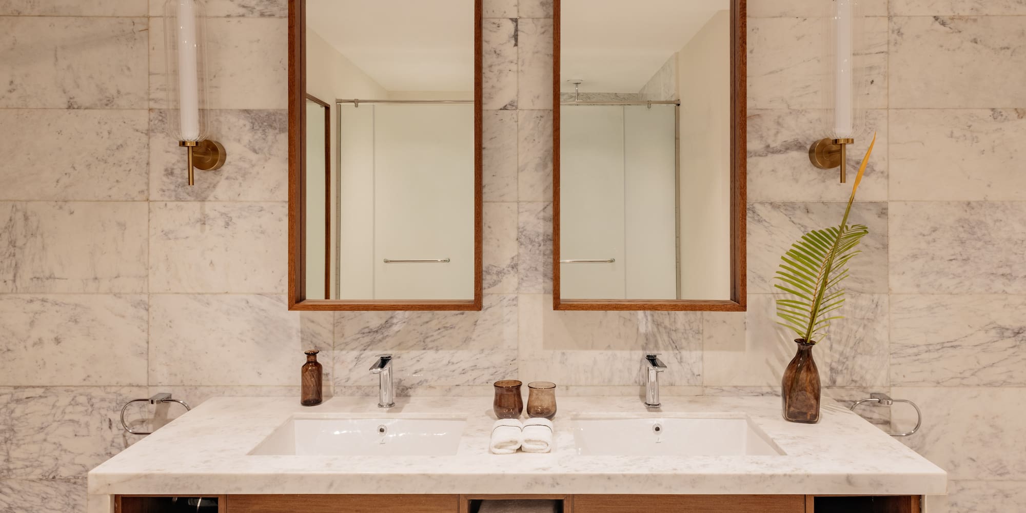 a bathroom with marble countertop sinks and mirrors