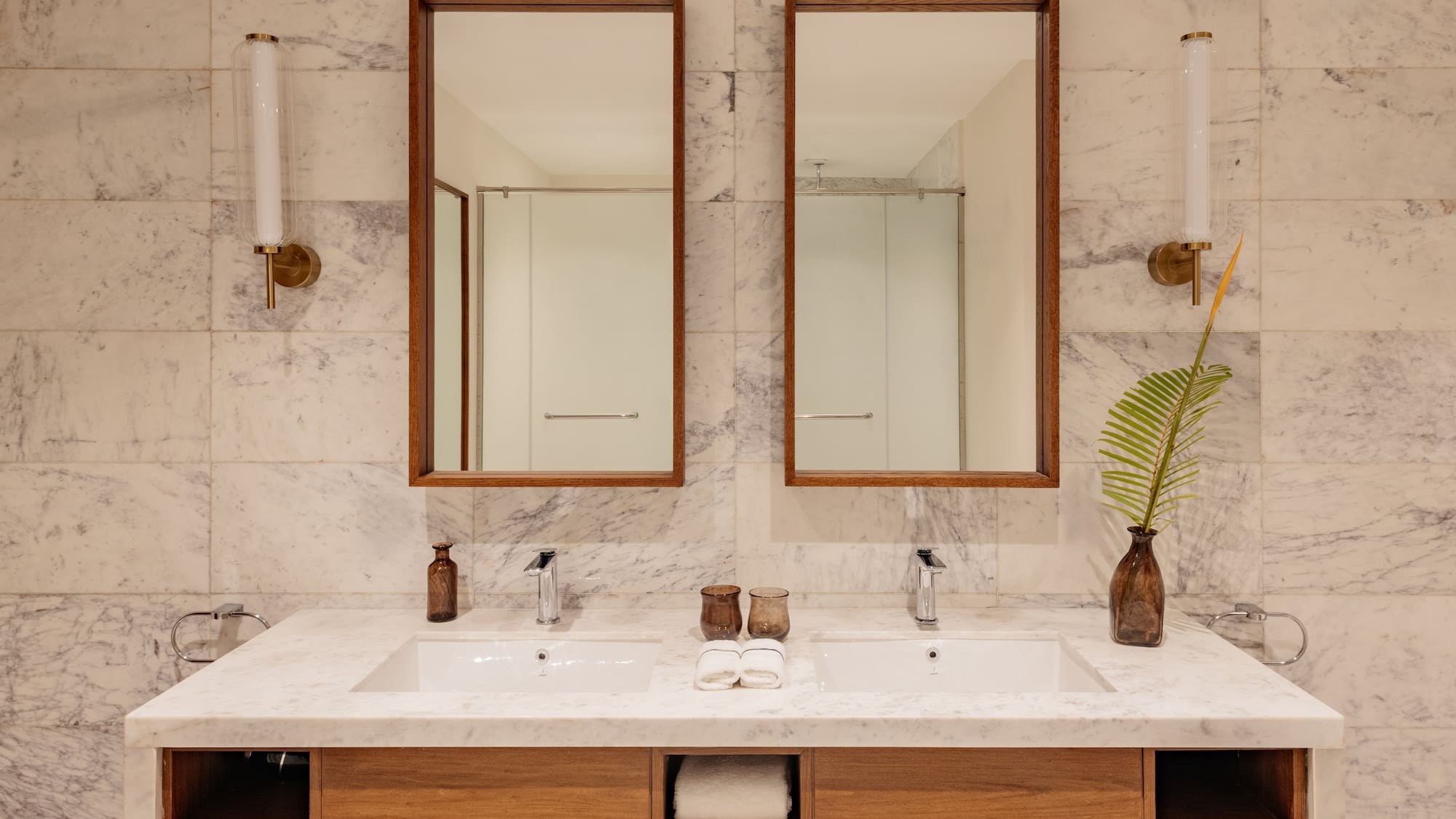 a bathroom with marble countertop sinks and mirrors
