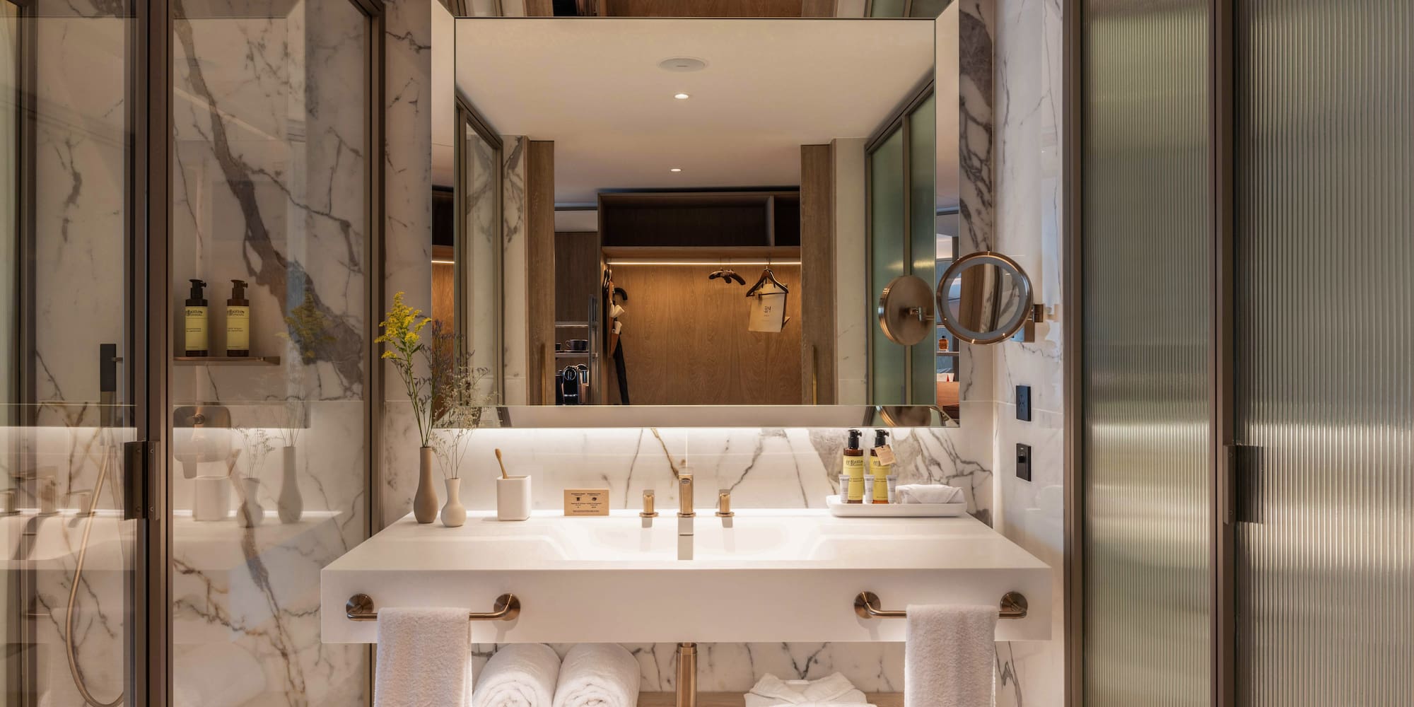 a bathroom with a large mirror and a sink