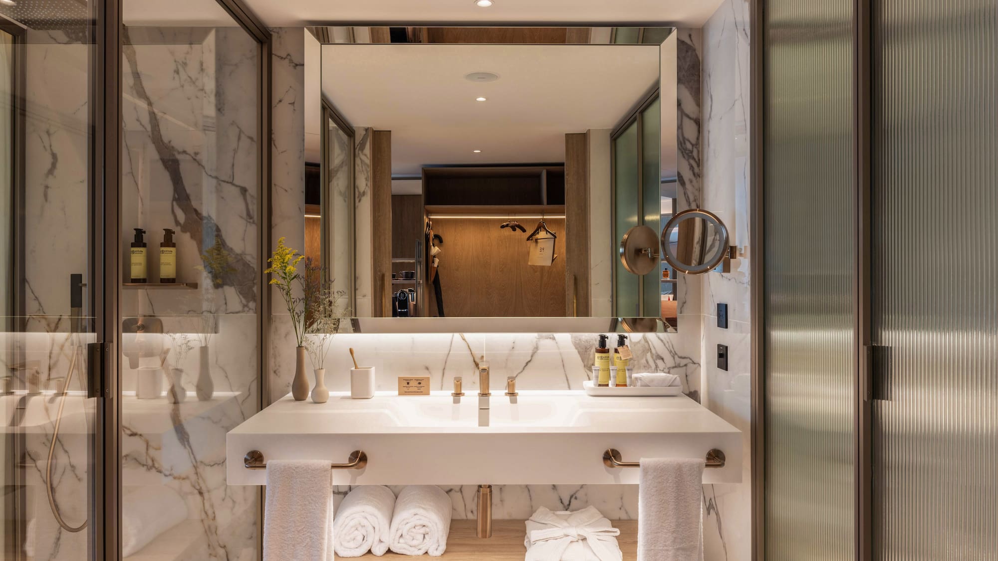 a bathroom with a large mirror and a sink