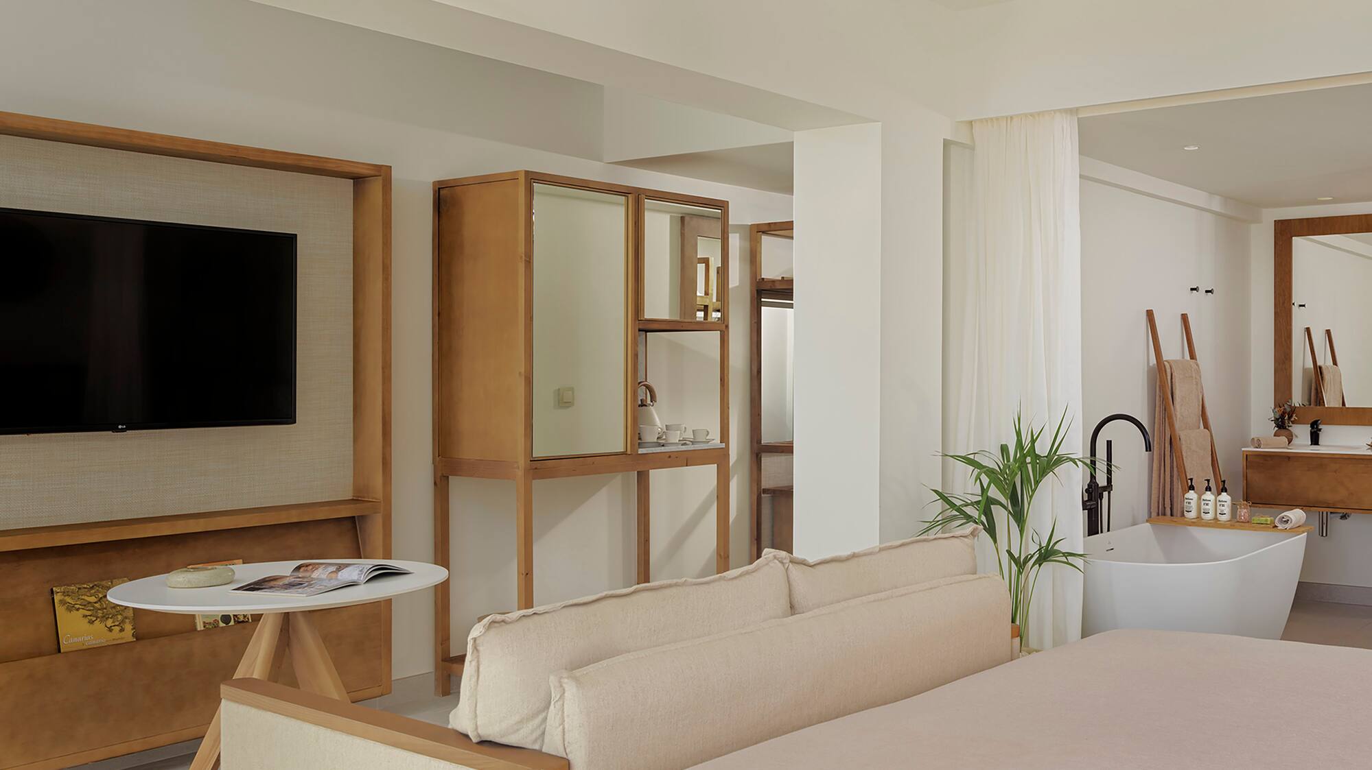 a room with a bed couch and a television