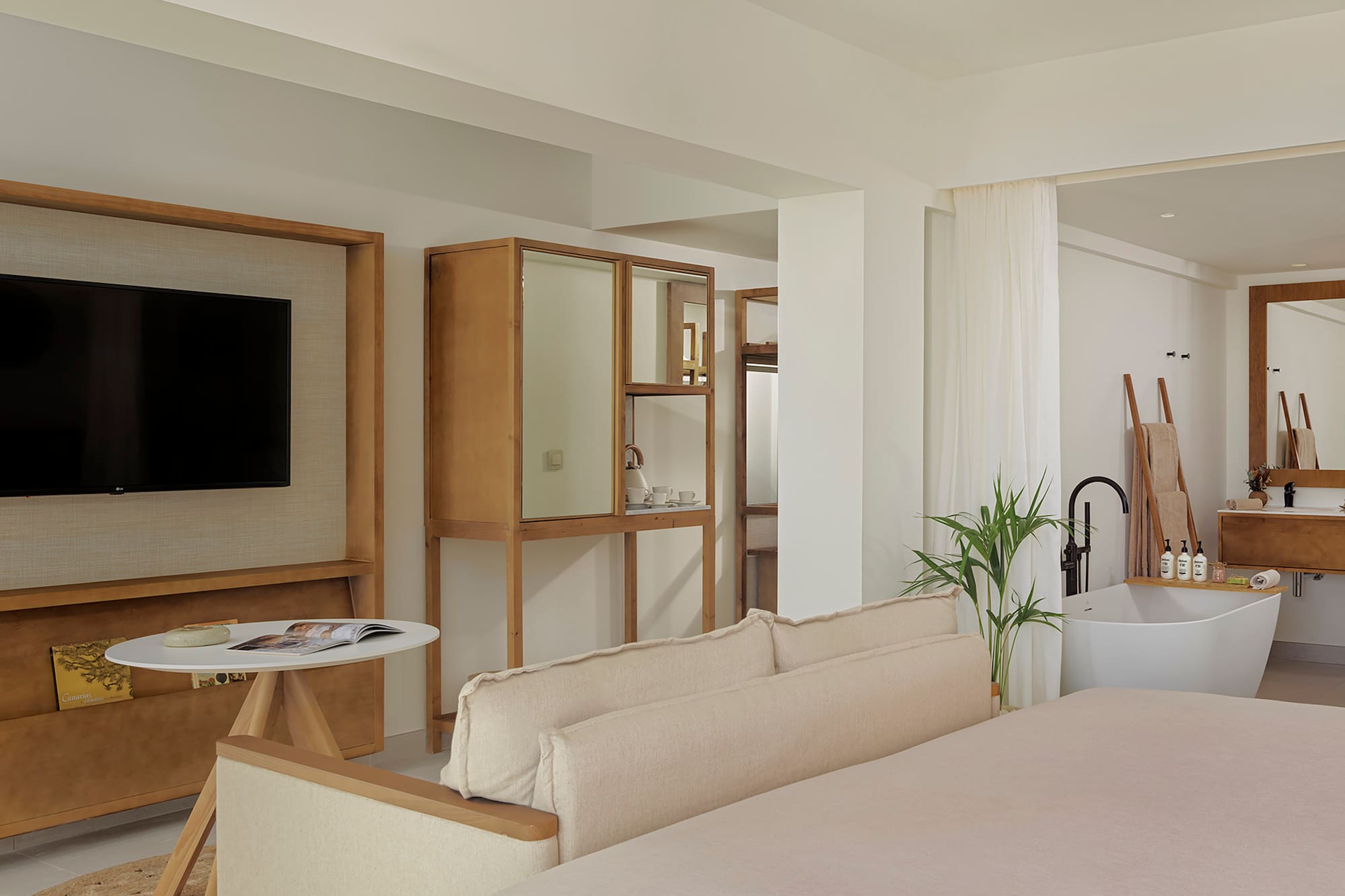 a room with a bed couch and a television