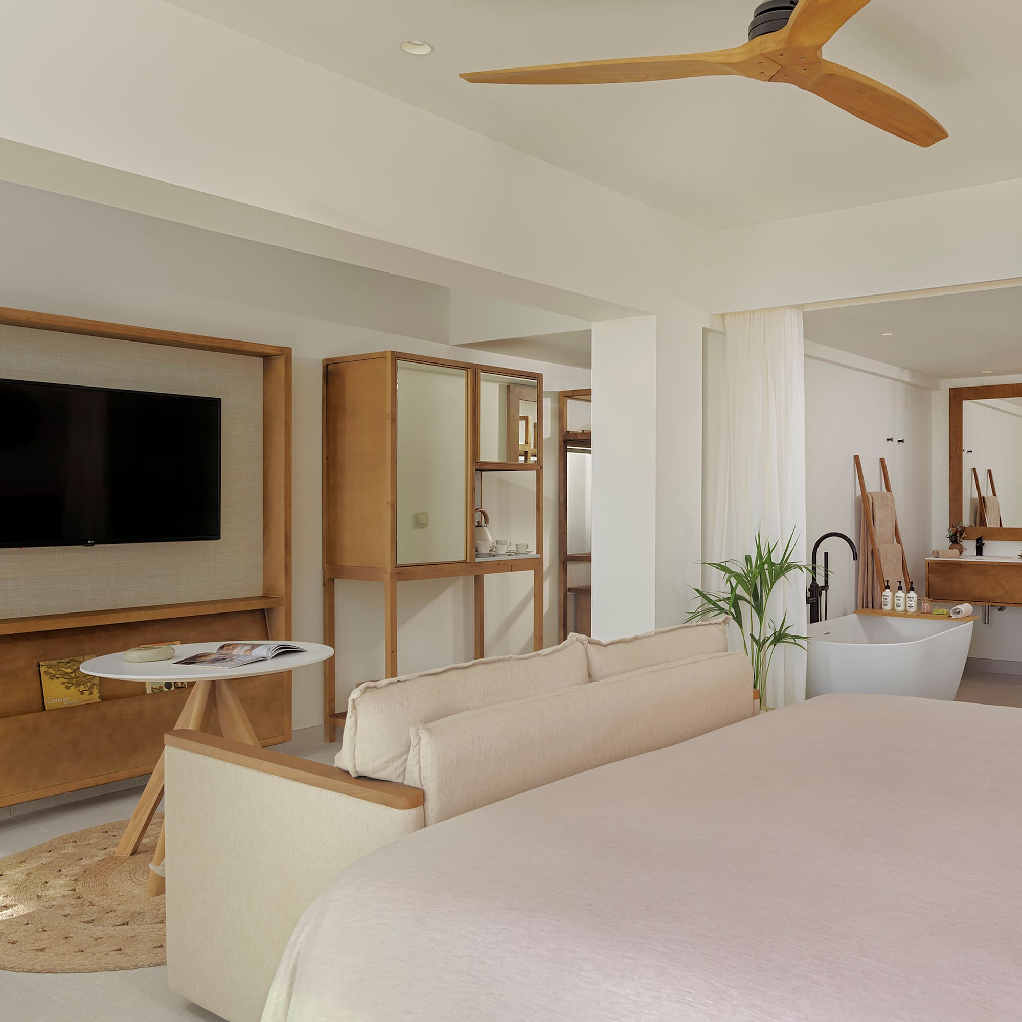 a room with a bed couch and a television