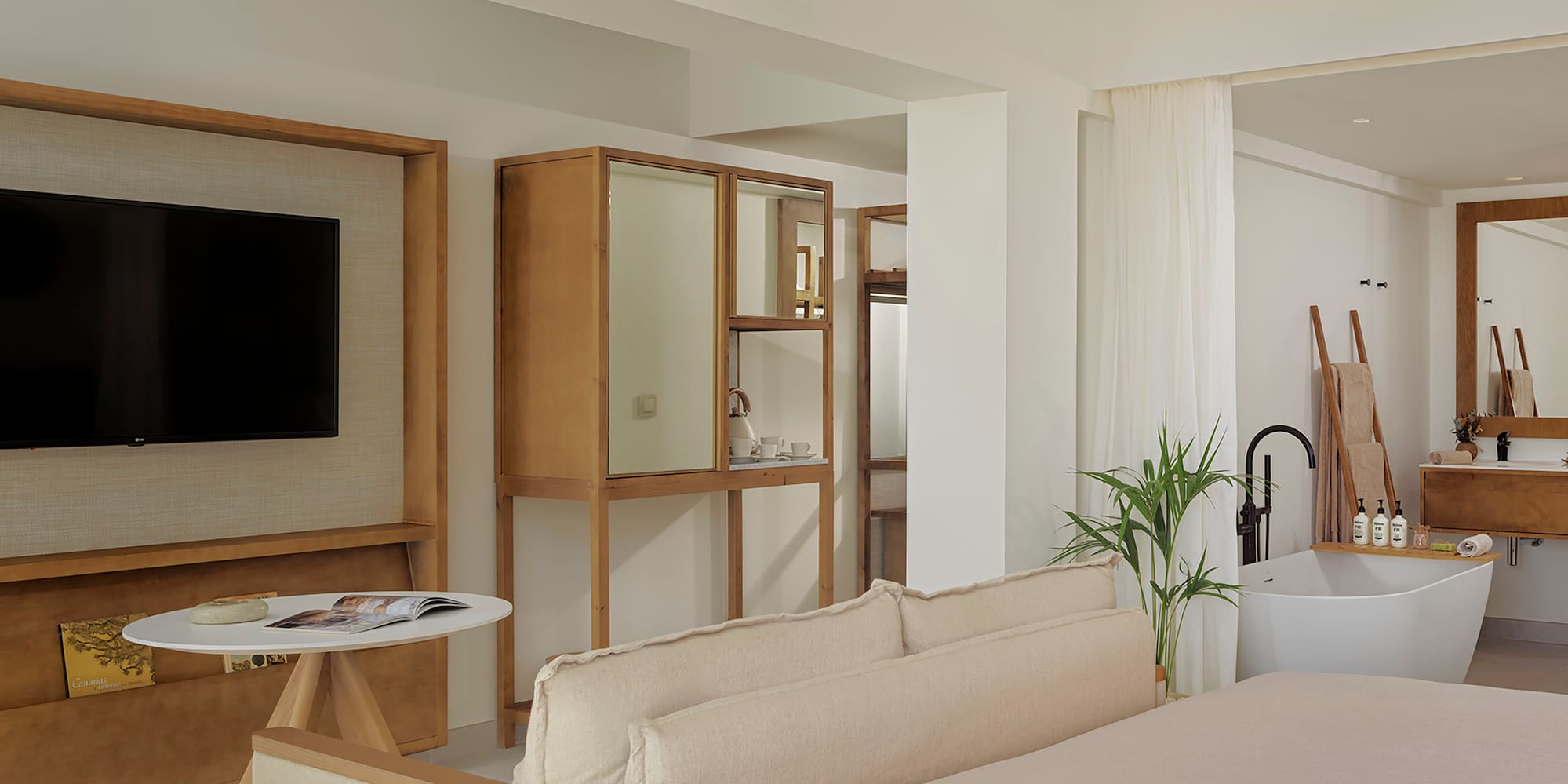 a room with a bed couch and a television