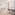 Bright studio apartment with sofa, dining table, and balcony access.