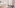 Bright studio apartment with sofa, dining table, and balcony access.