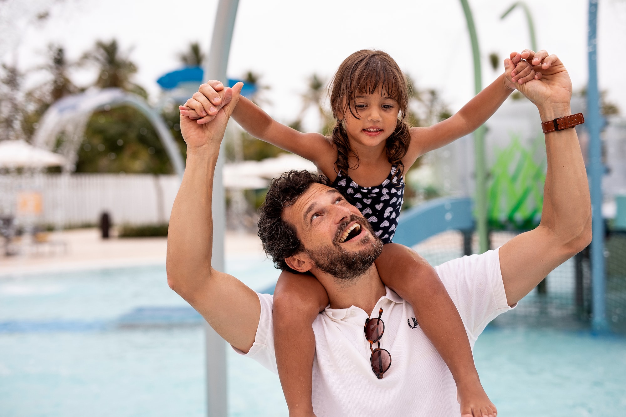 a man carrying a child on his shoulders