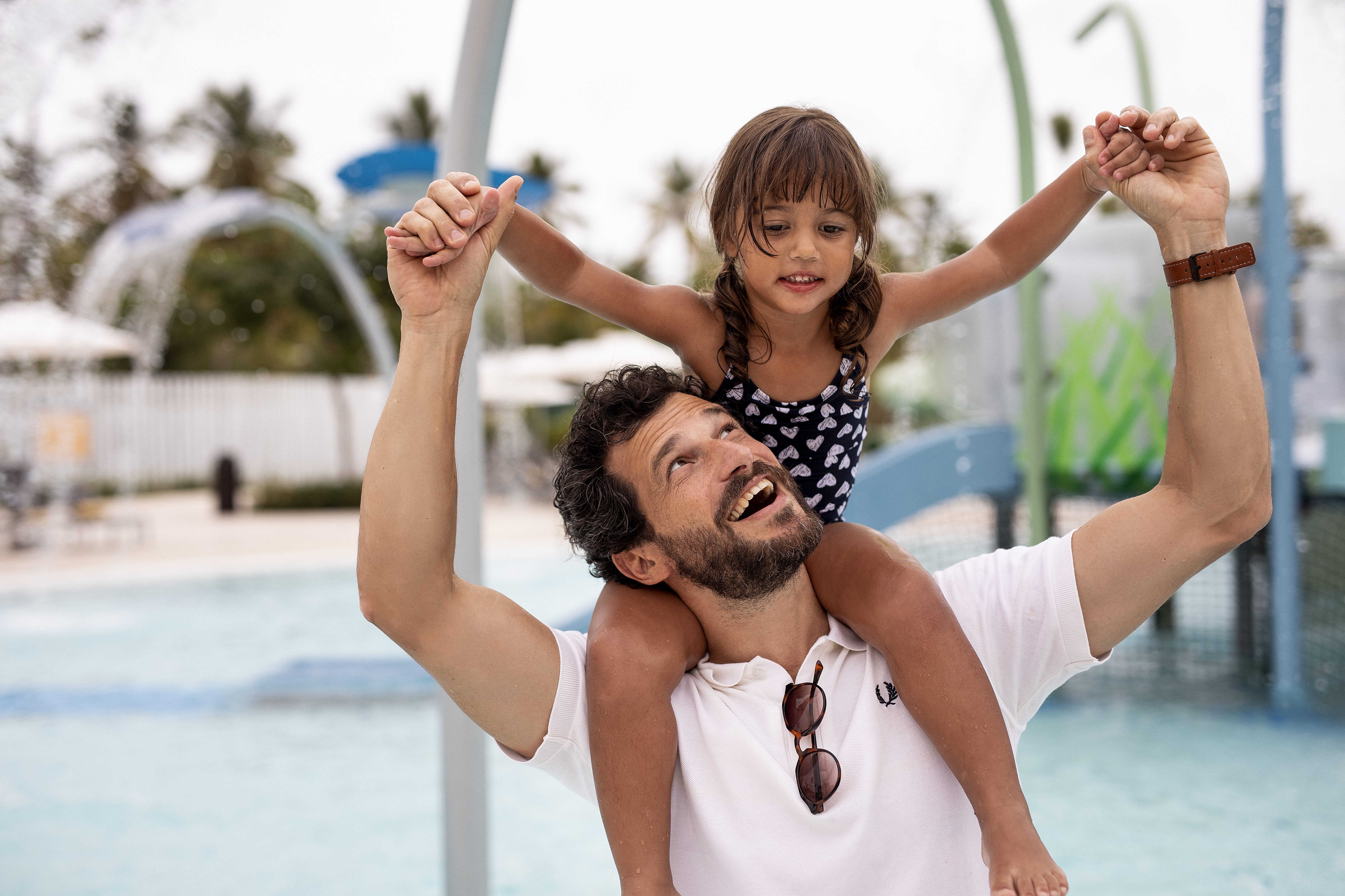 a man carrying a child on his shoulders