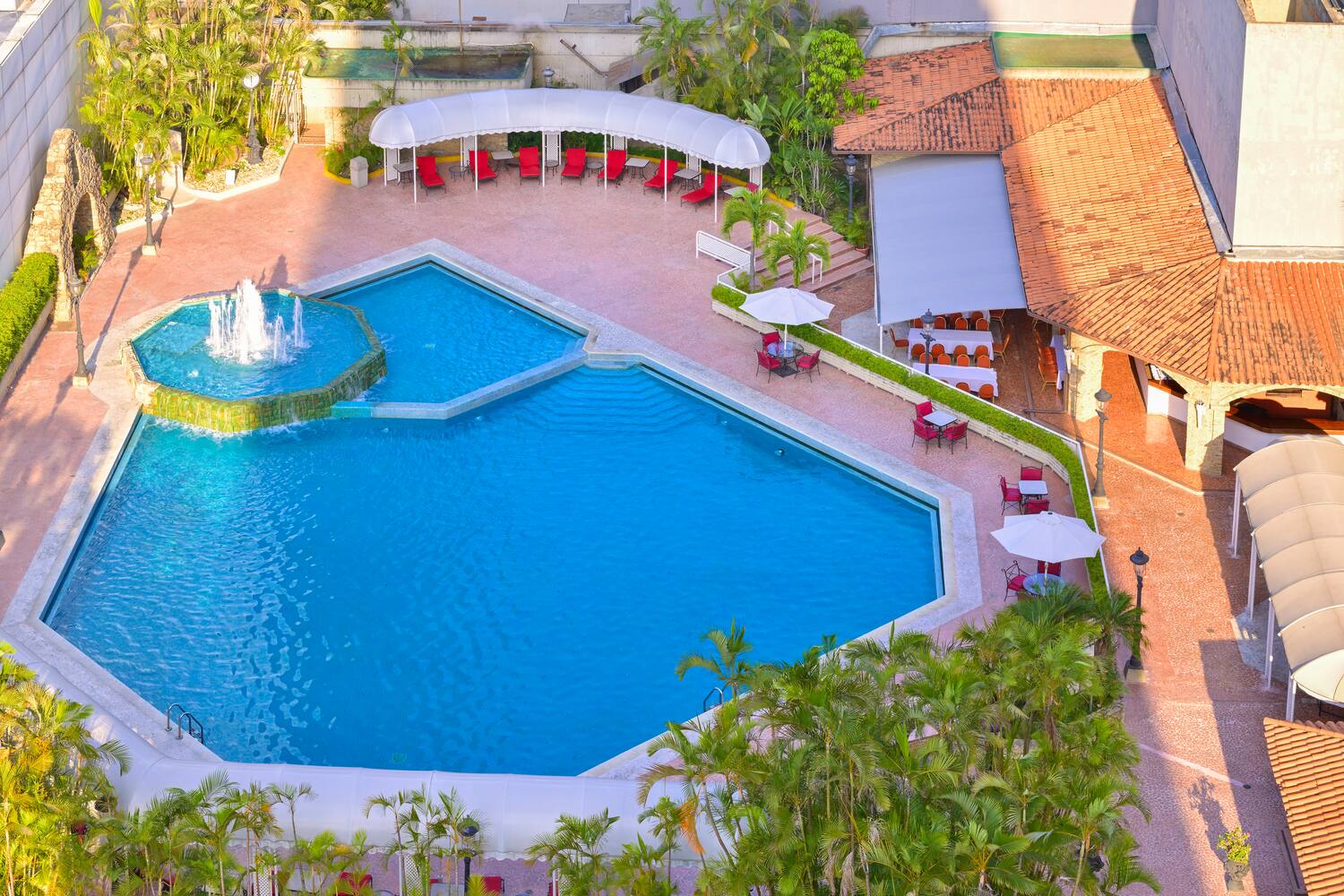 a pool with a fountain and a fountain in the middle
