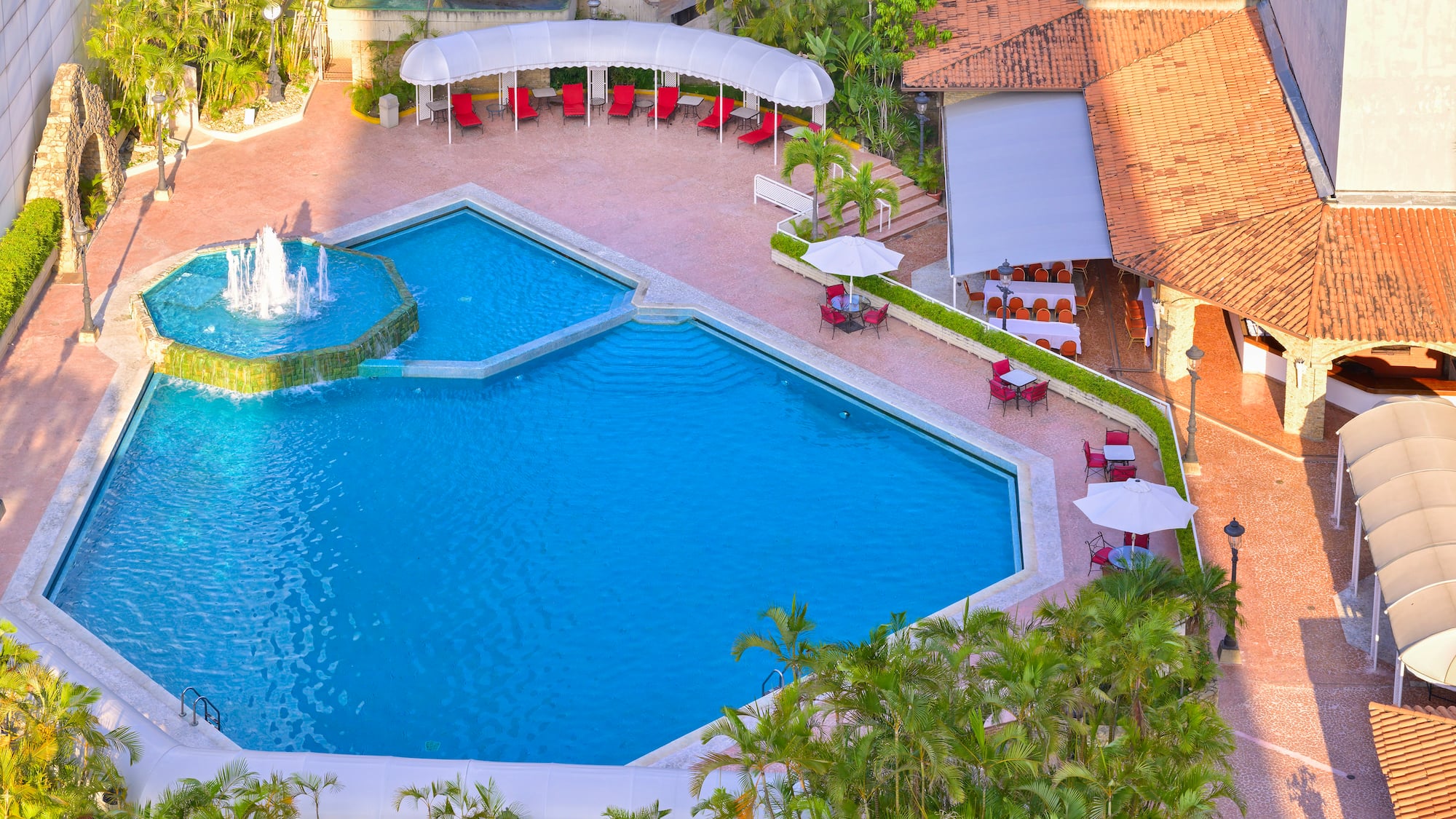 a pool with a fountain and a fountain in the middle