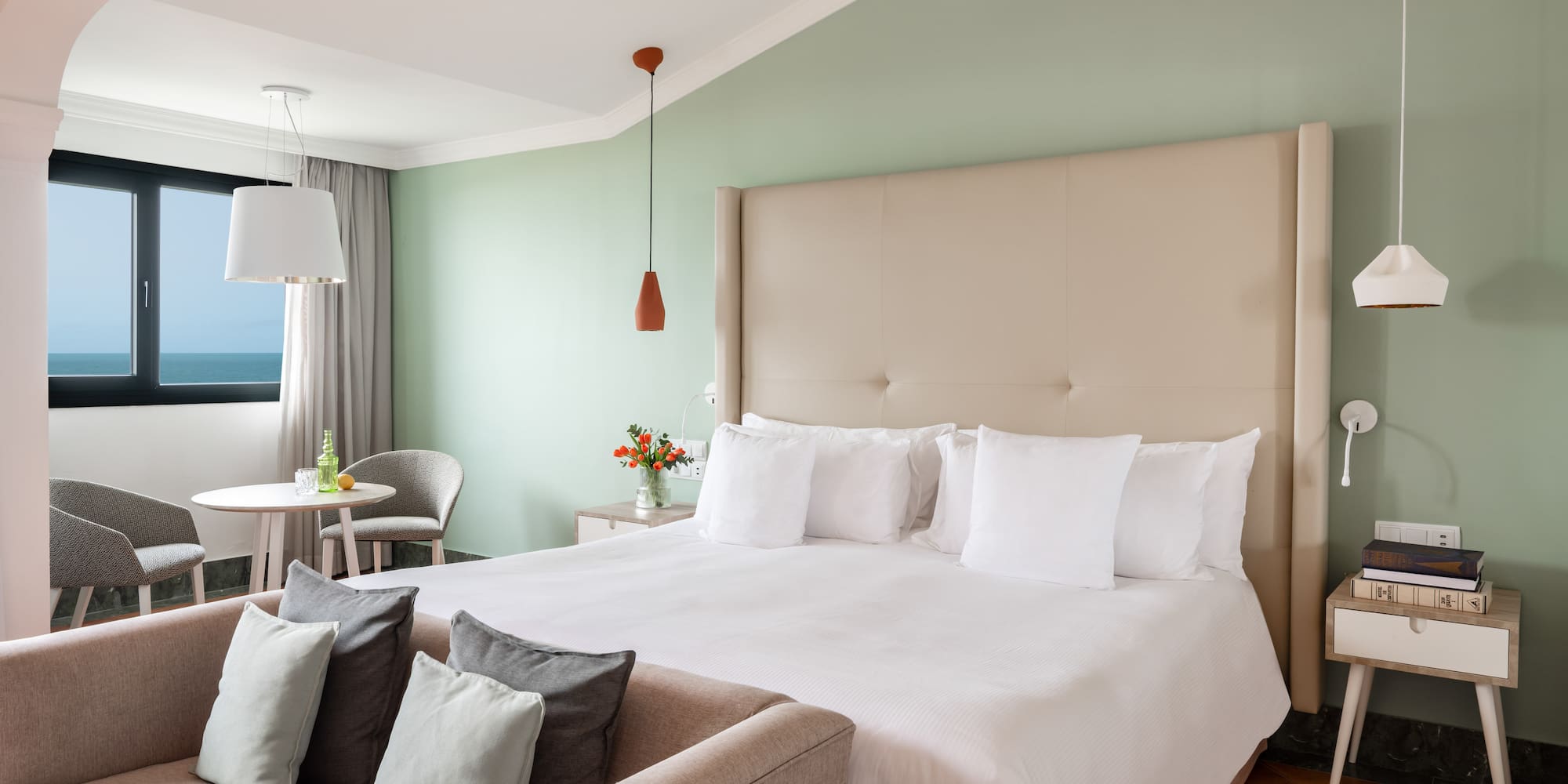 a bedroom with a bed and a table and chairs