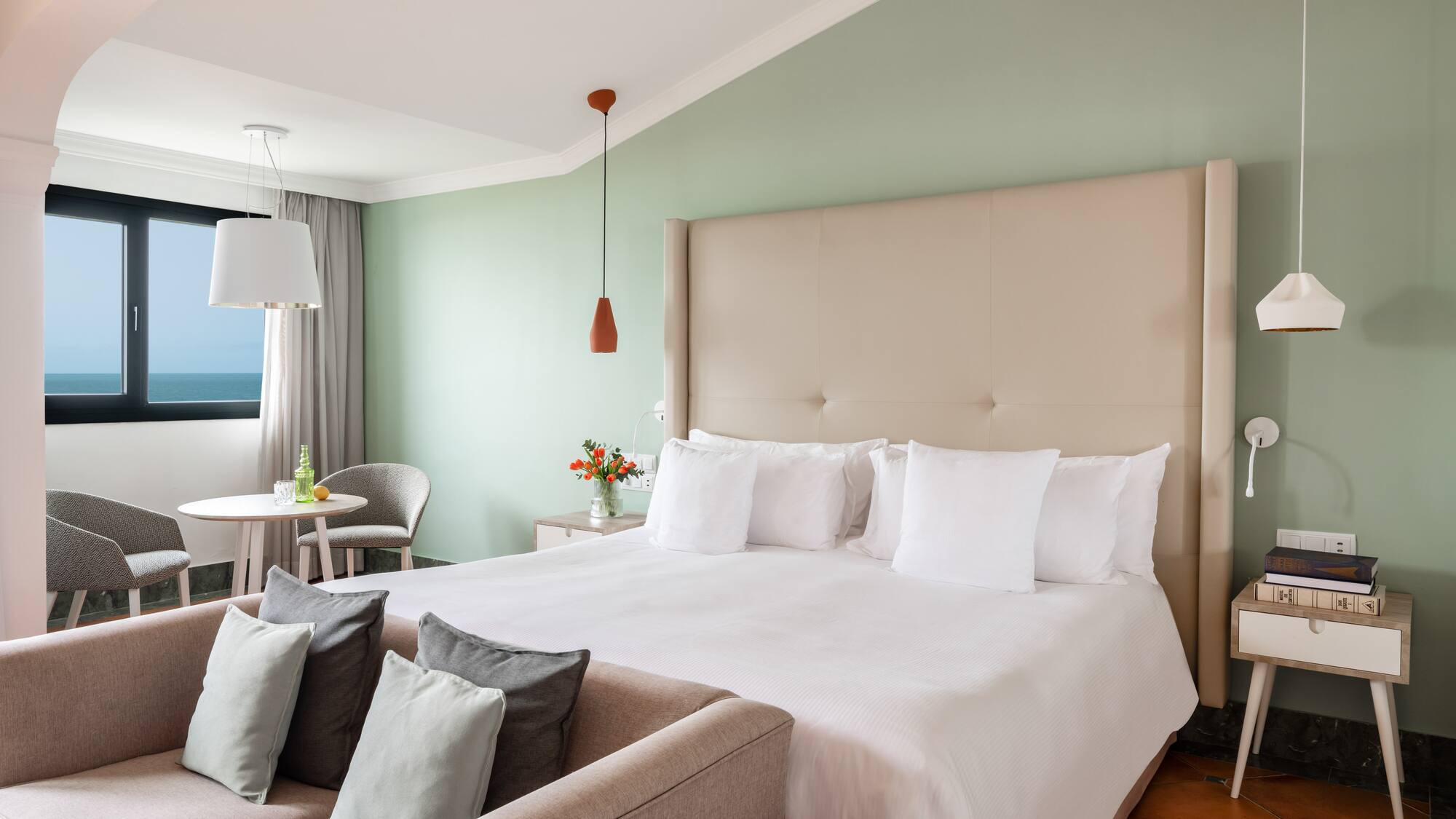 a bedroom with a bed and a table and chairs