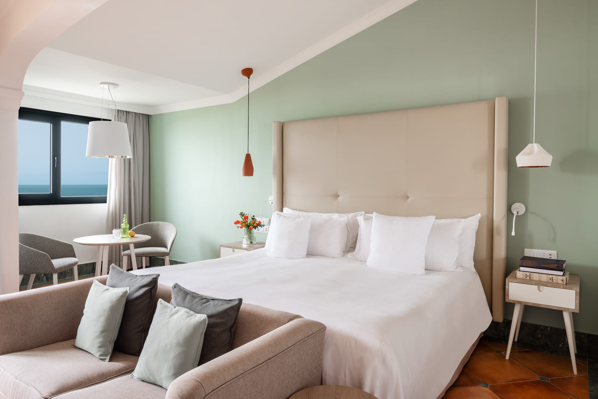 a bedroom with a bed and a table and chairs