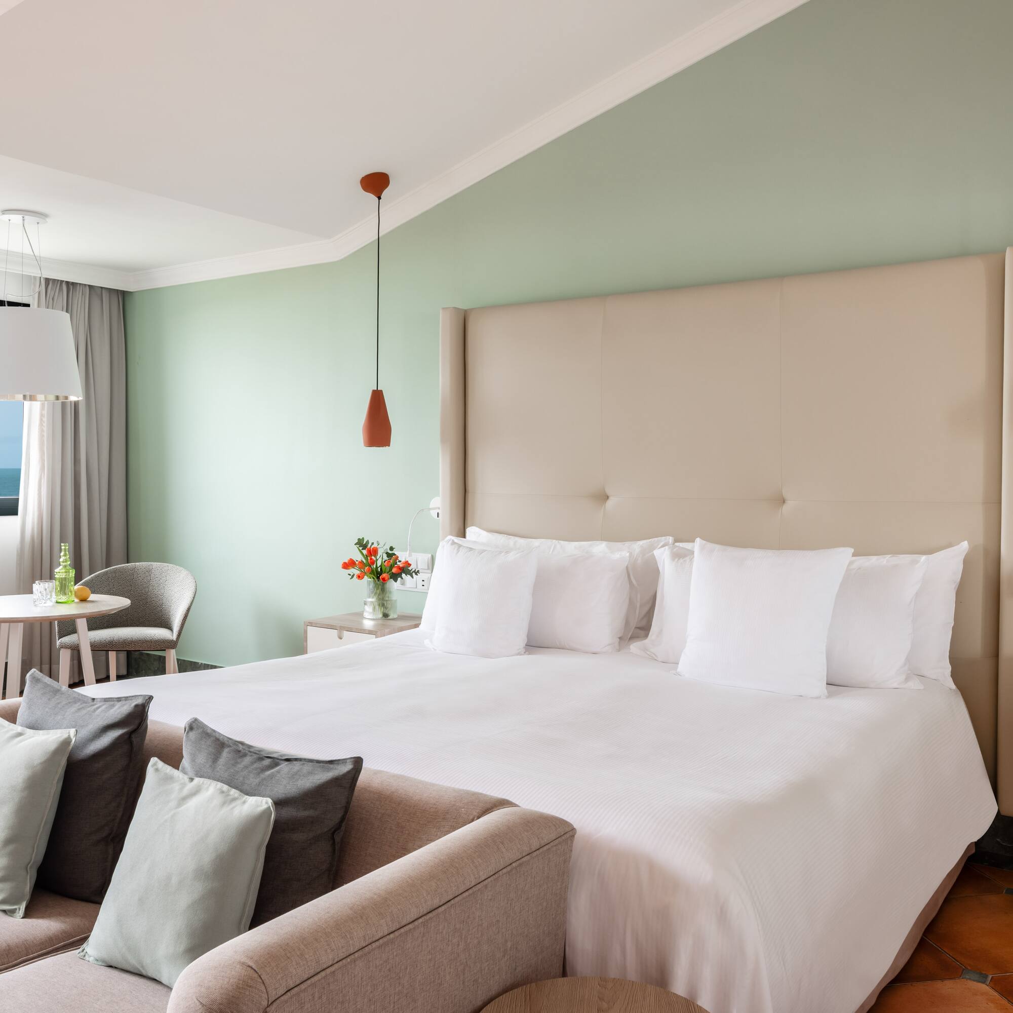 a bedroom with a bed and a table and chairs